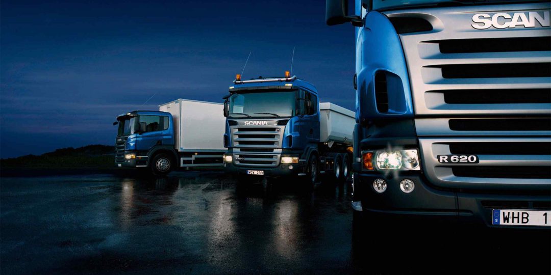 Three-trucks-on-blue-background-1-1080x540.jpg